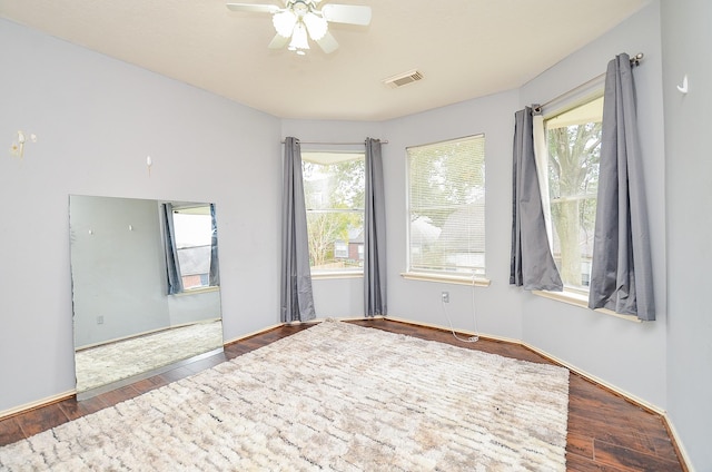 spare room featuring dark hardwood / wood-style flooring and ceiling fan