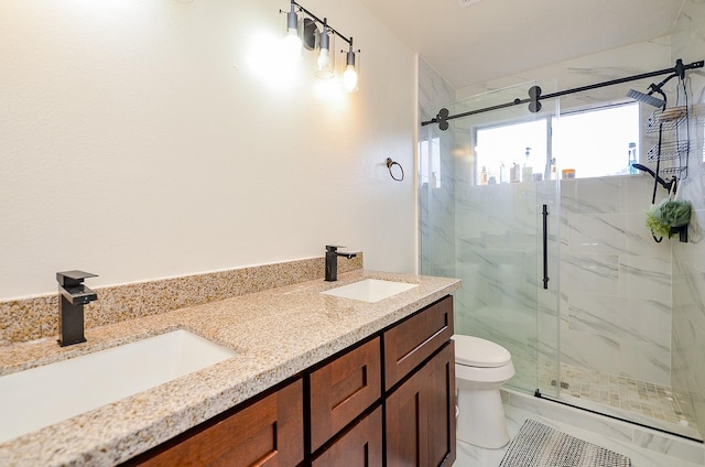 bathroom with vanity, a shower with shower door, and toilet