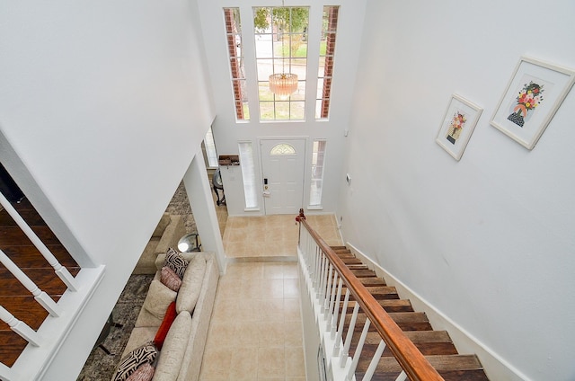 tiled entrance foyer featuring a high ceiling