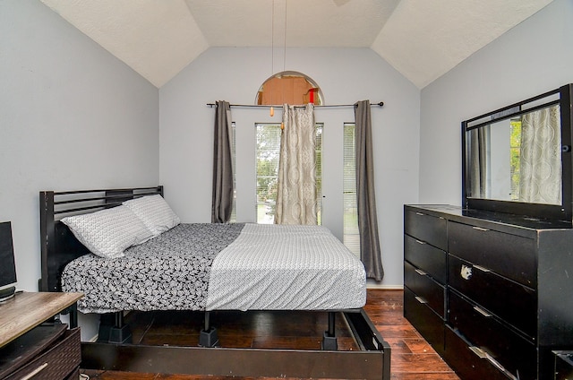 bedroom with dark hardwood / wood-style flooring and lofted ceiling