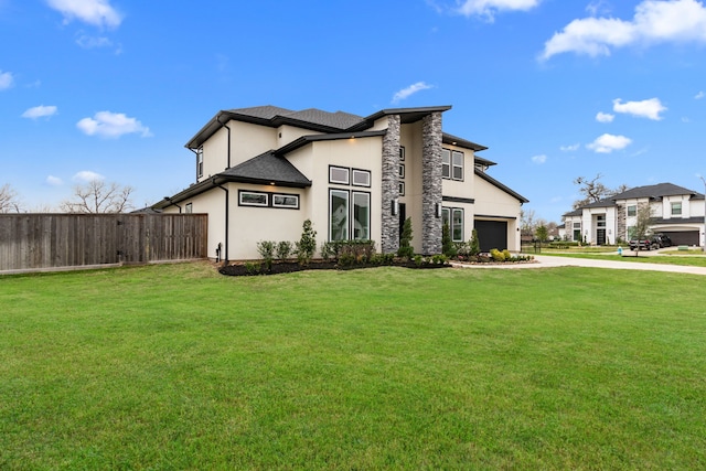 view of front facade featuring a garage and a front lawn