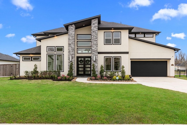 prairie-style home with a garage and a front lawn