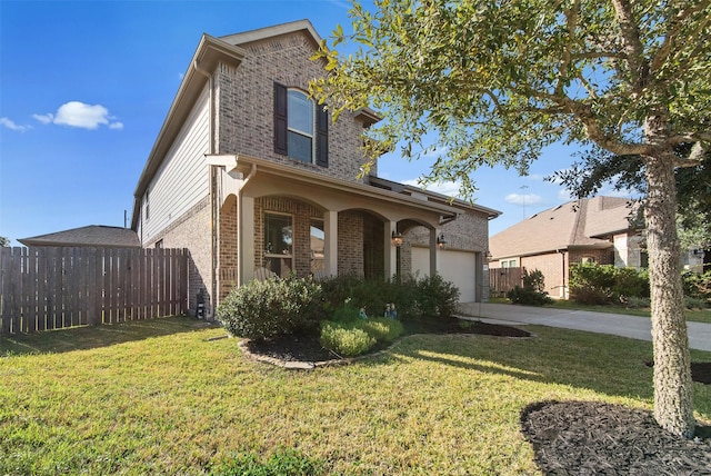 front of property featuring a front lawn, covered porch, and a garage