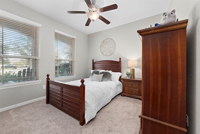 bedroom with light colored carpet and ceiling fan