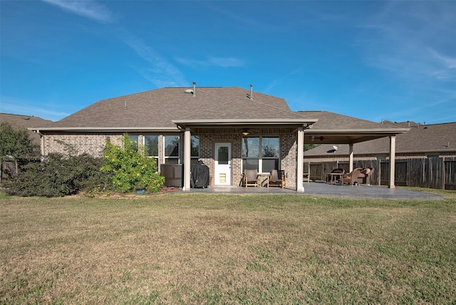 rear view of property featuring a patio, ceiling fan, and a lawn