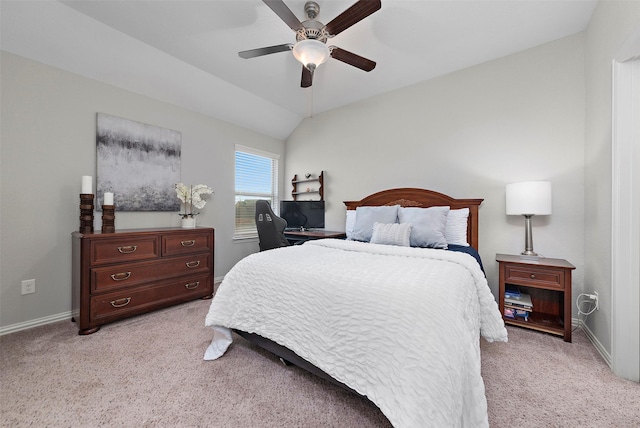 bedroom with ceiling fan, light colored carpet, and vaulted ceiling