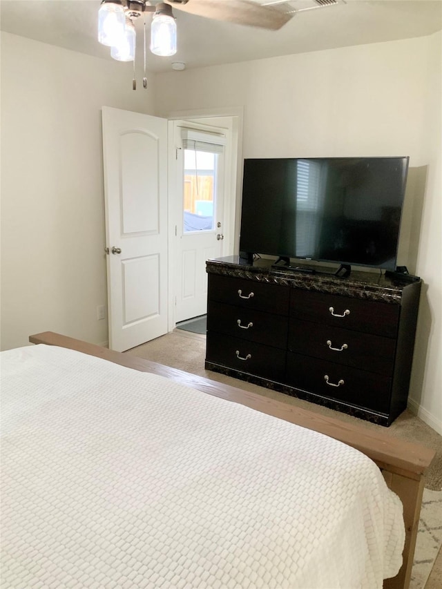 bedroom with light colored carpet and ceiling fan