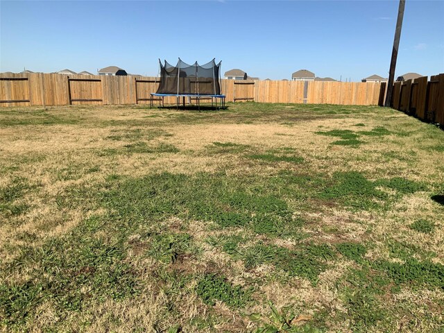 view of yard with a trampoline