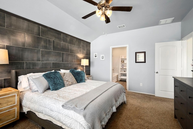 bedroom with dark colored carpet, connected bathroom, ceiling fan, and lofted ceiling