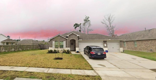 view of front of property featuring a yard and a garage