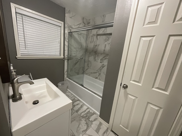 bathroom featuring shower / bath combination with glass door and sink