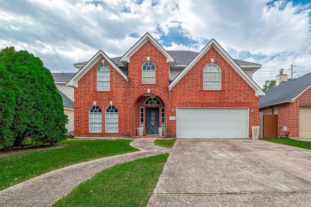 front of property with a garage and a front lawn