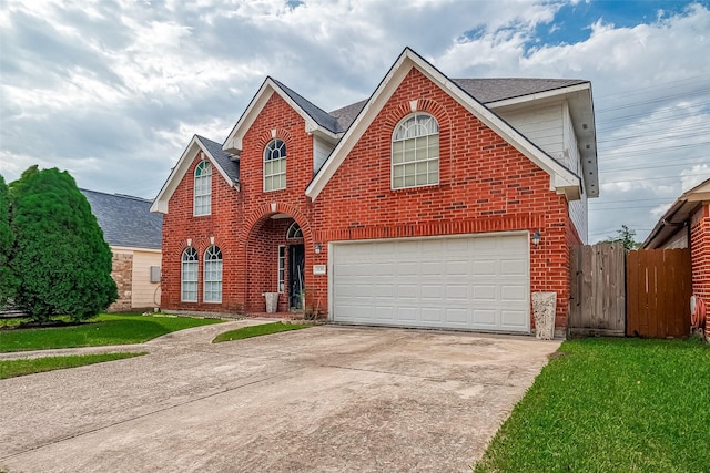 view of property featuring a front yard and a garage