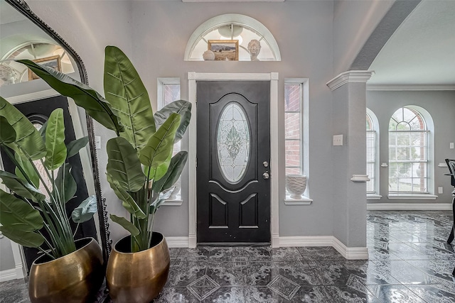 entrance foyer with ornamental molding and decorative columns