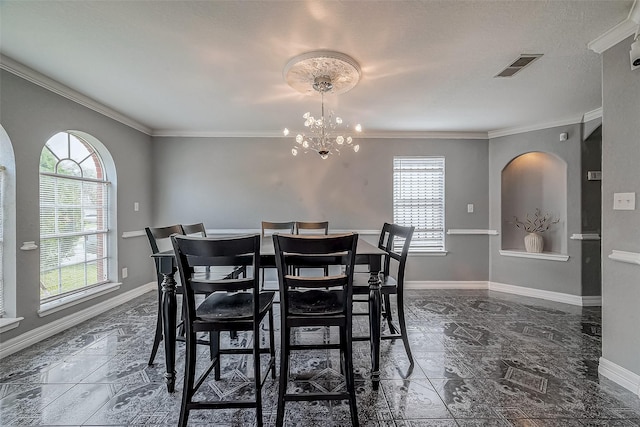 dining space featuring crown molding and a chandelier