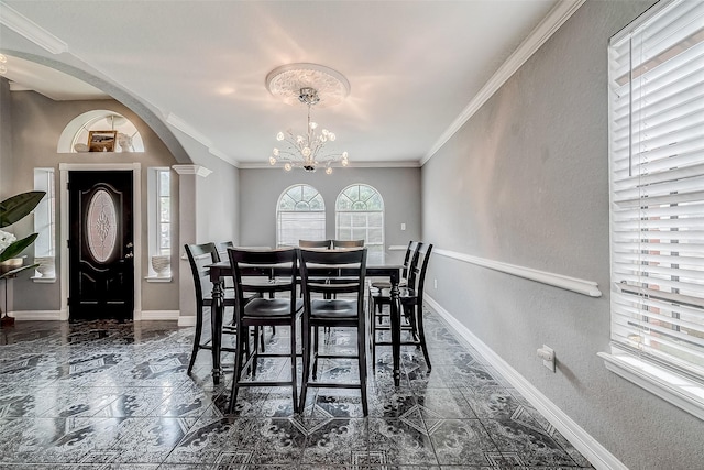 dining area featuring ornamental molding, ornate columns, and a notable chandelier