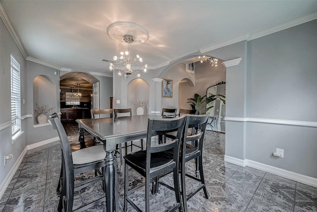 dining area with a chandelier and ornamental molding