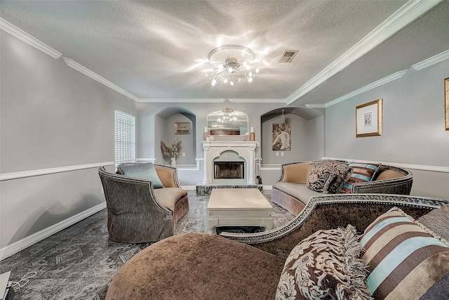 living room with a textured ceiling, ceiling fan, and crown molding