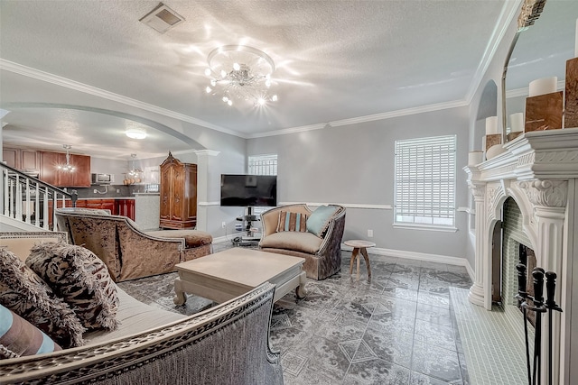 living room with a textured ceiling, an inviting chandelier, and ornamental molding