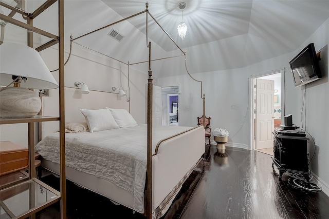 bedroom featuring lofted ceiling and wood-type flooring