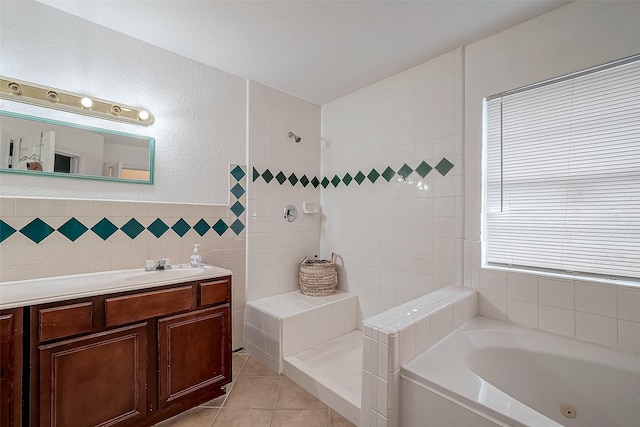 bathroom with tile patterned floors, vanity, tile walls, and independent shower and bath