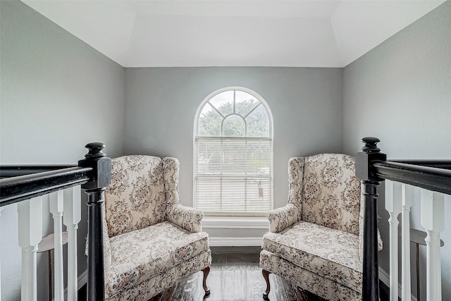 sitting room with hardwood / wood-style flooring and vaulted ceiling