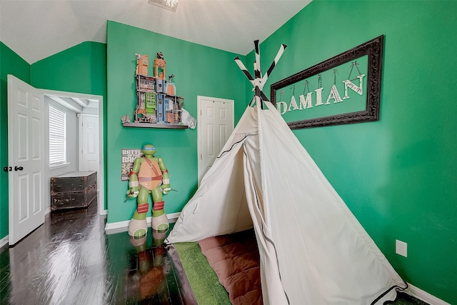 bedroom with hardwood / wood-style floors and vaulted ceiling