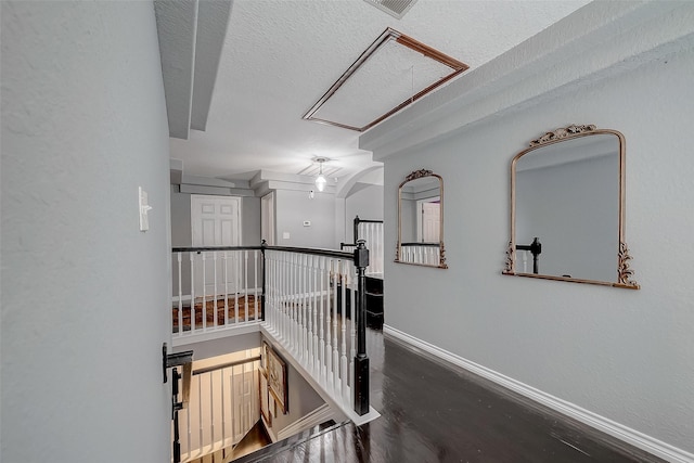 hall featuring dark hardwood / wood-style flooring and a textured ceiling