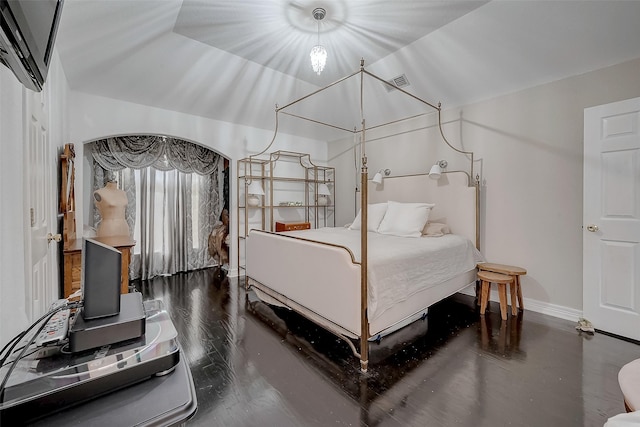 bedroom with dark hardwood / wood-style flooring and vaulted ceiling