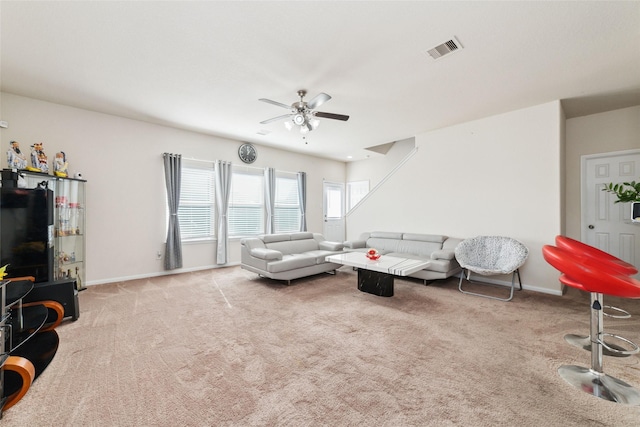 carpeted living room featuring ceiling fan