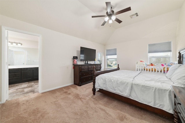 carpeted bedroom with connected bathroom, ceiling fan, and lofted ceiling