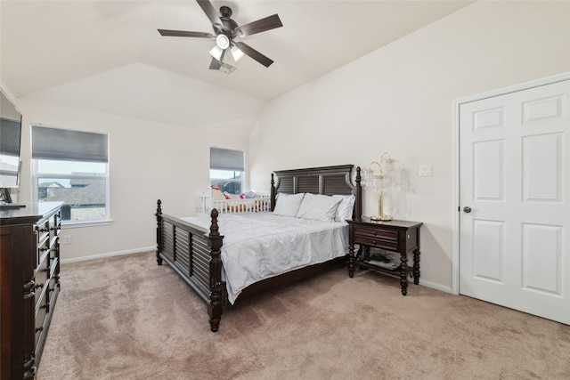 bedroom featuring ceiling fan, light colored carpet, and vaulted ceiling