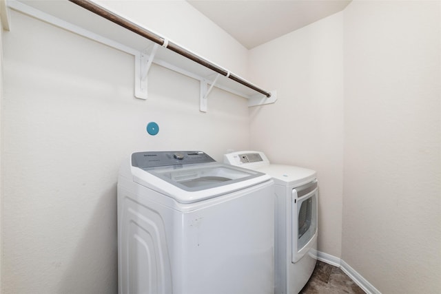 clothes washing area featuring washer and clothes dryer