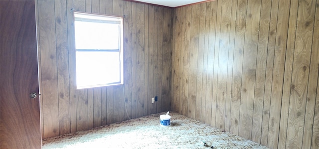 empty room featuring wood walls