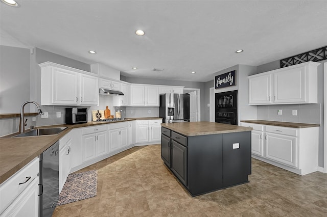 kitchen featuring a kitchen island, white cabinetry, black appliances, and sink