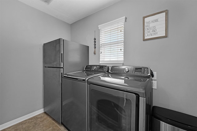 laundry area with washer and dryer and tile patterned flooring