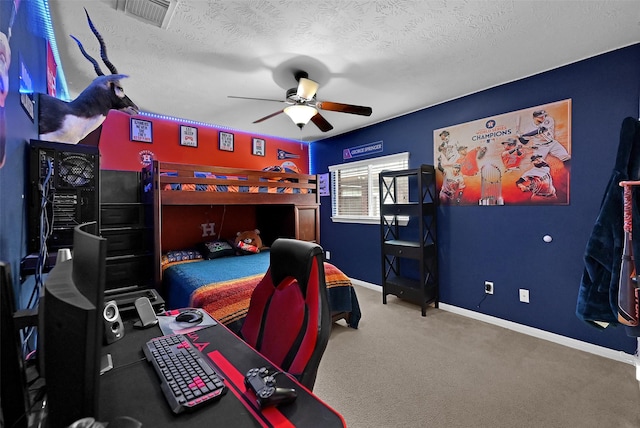 carpeted bedroom with ceiling fan and a textured ceiling