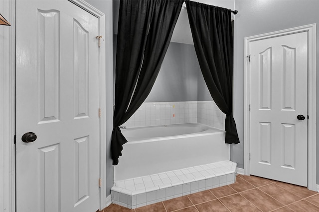 bathroom featuring a bath and tile patterned floors