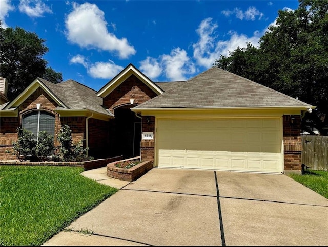 ranch-style house featuring a front yard and a garage