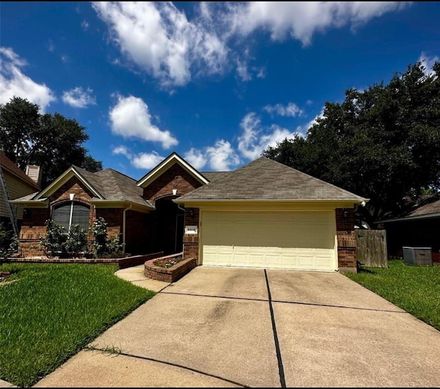 single story home featuring a garage and a front yard