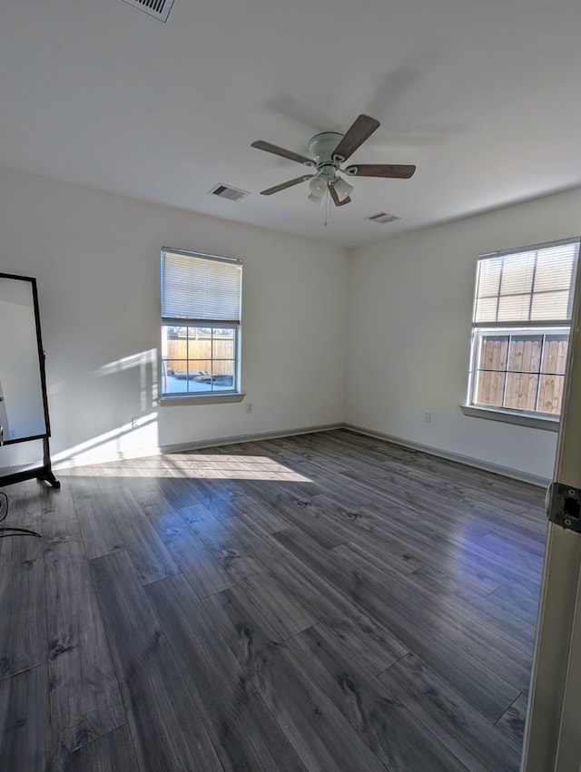 empty room featuring ceiling fan and dark hardwood / wood-style flooring