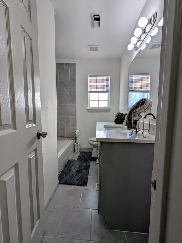 bathroom featuring tile patterned floors, vanity, and toilet