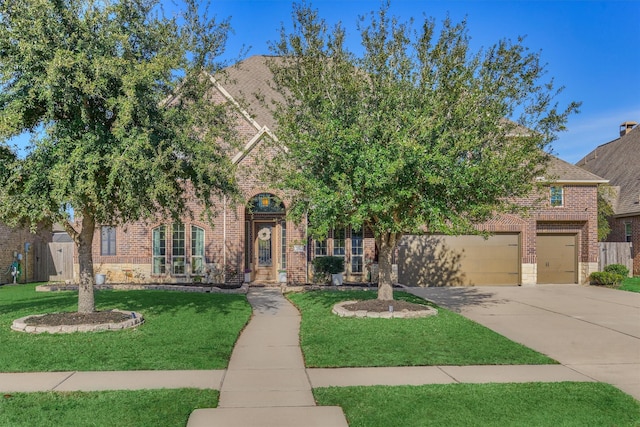 view of property hidden behind natural elements with a garage and a front lawn