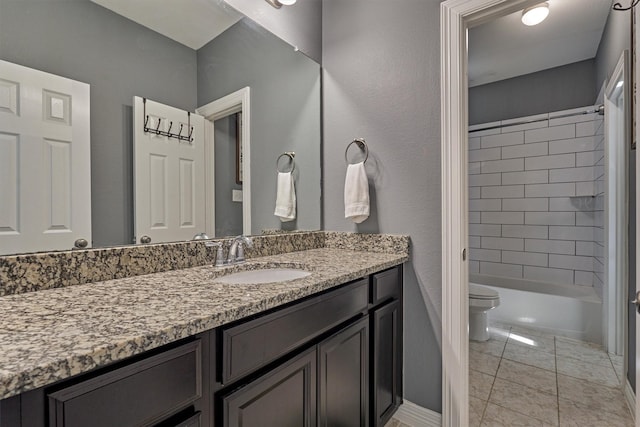 full bathroom with tiled shower / bath, tile patterned floors, vanity, and toilet