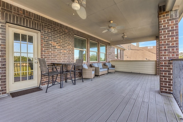 wooden terrace with outdoor lounge area and ceiling fan