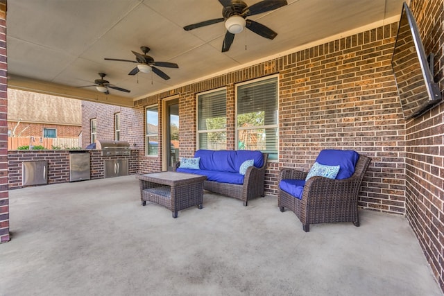 view of patio featuring area for grilling, ceiling fan, outdoor lounge area, and exterior kitchen