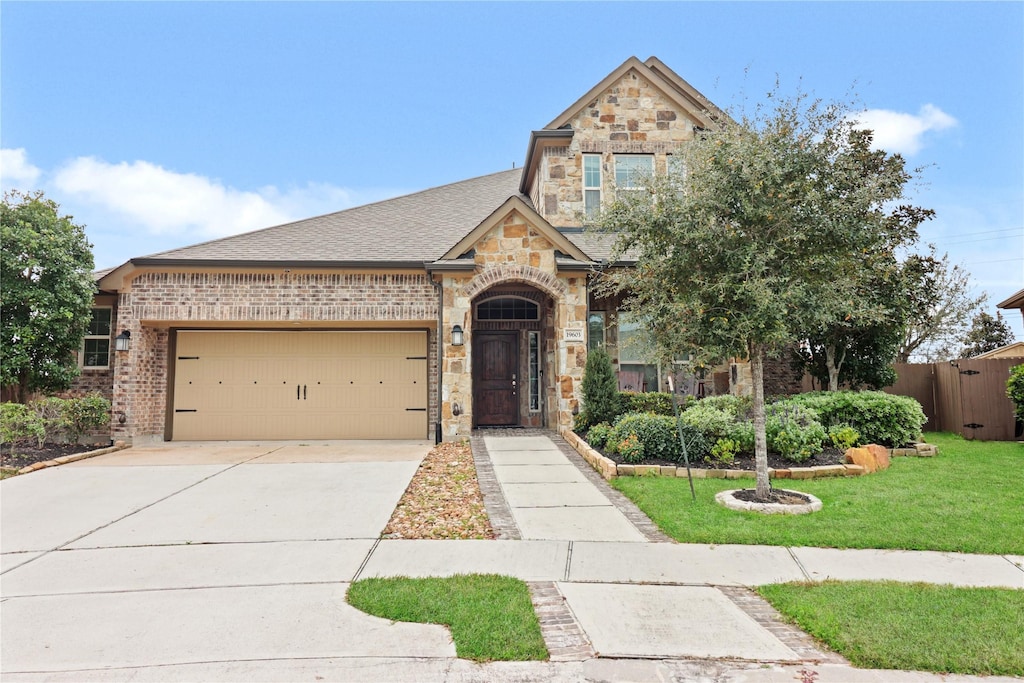 view of front of home with a front yard and a garage