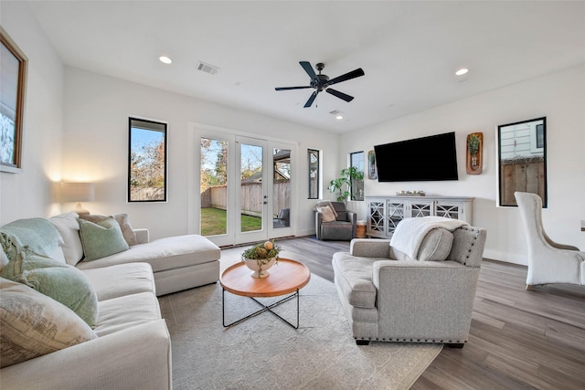 living room with ceiling fan, french doors, and hardwood / wood-style flooring