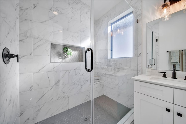 bathroom with vanity and a shower with shower door