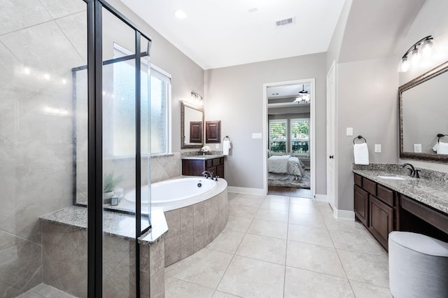 bathroom featuring ceiling fan, tile patterned floors, vanity, and plus walk in shower